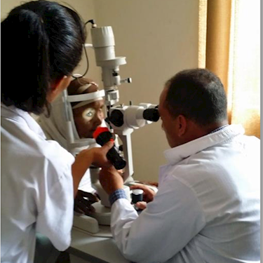 Doctor performing eye exam with a flashlight